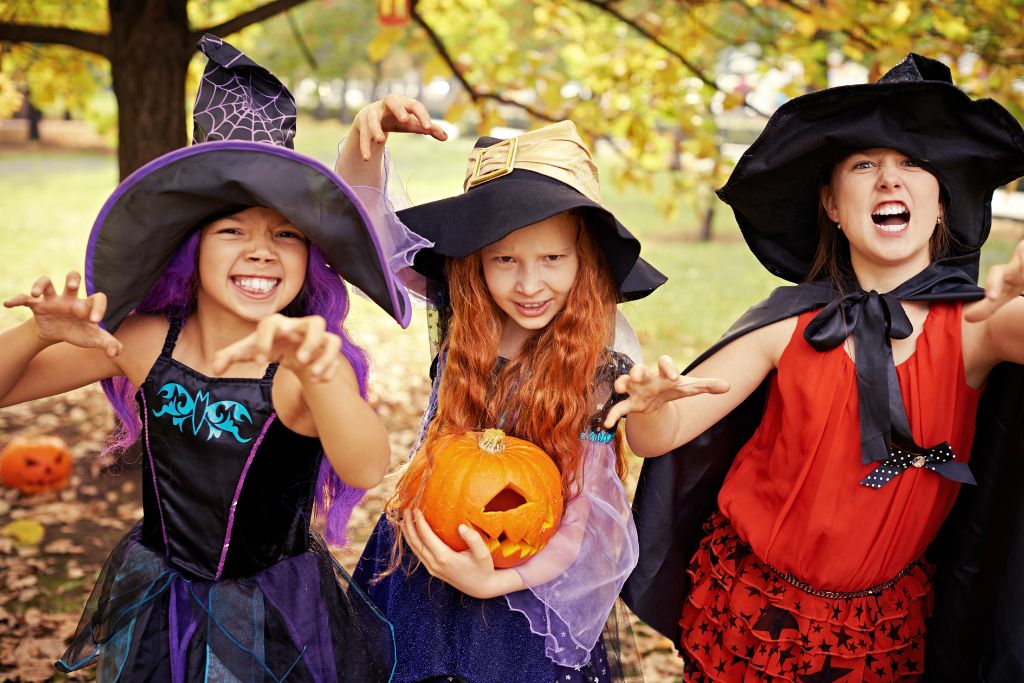 Trick or treaters make faces at the camera. Tips for trick or treating are a part of this American guide to Halloween in the UK.