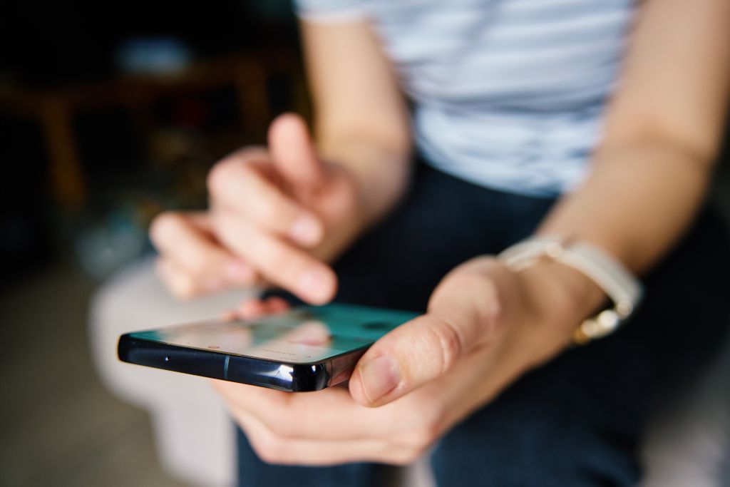Close up image of a person holding a mobile phone.
