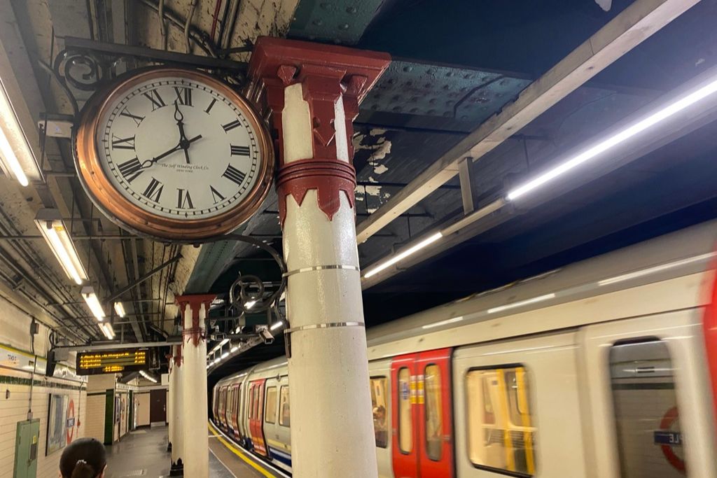 London Tube station with a train entering.