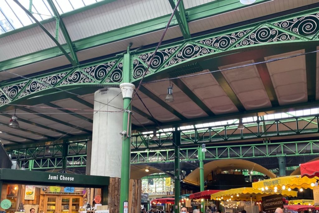 Borough Market in London England. The market stalls are set below the overhead train lines.