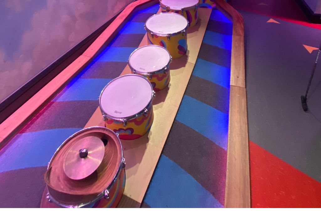 A set of drums on a putting green at Puttshack in London.