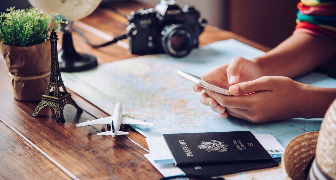 Travel apps for UK and Europe travel person using phone app with passport