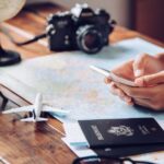 Travel apps for UK and Europe travel person using phone app with passport