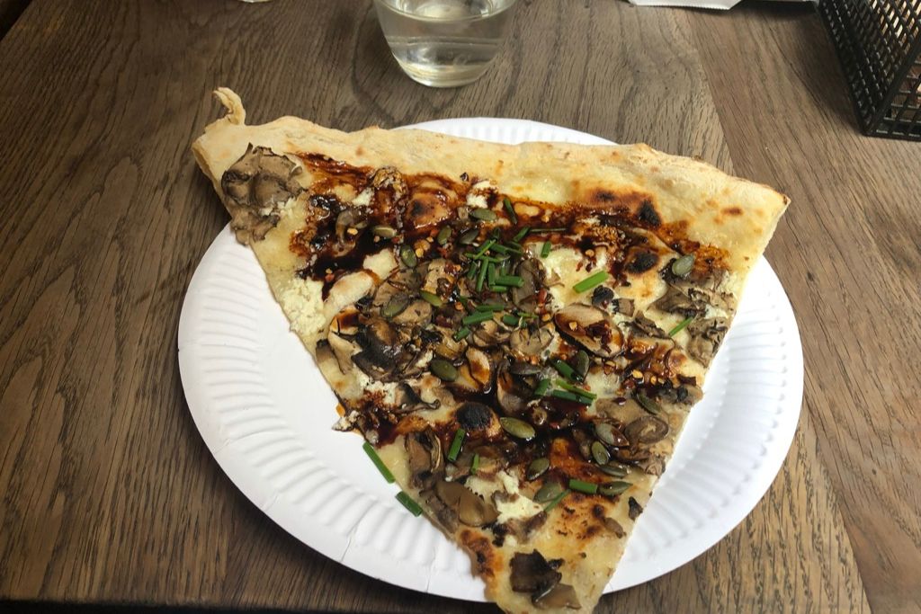 Slice of pizza at Homeslice Neal's Yard in the Covent Garden neighborhood of London.