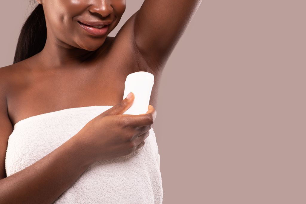 woman applying deodorant