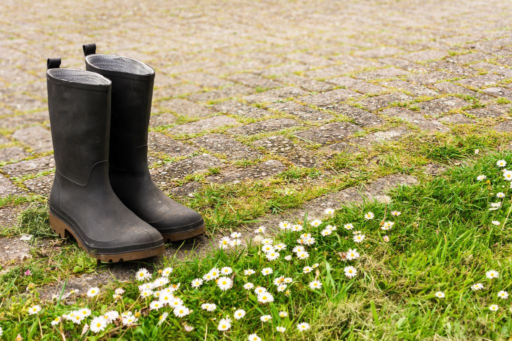 Wellies on a garden path. Americans often find the UK damper than expected and need to bring waterproof clothing.