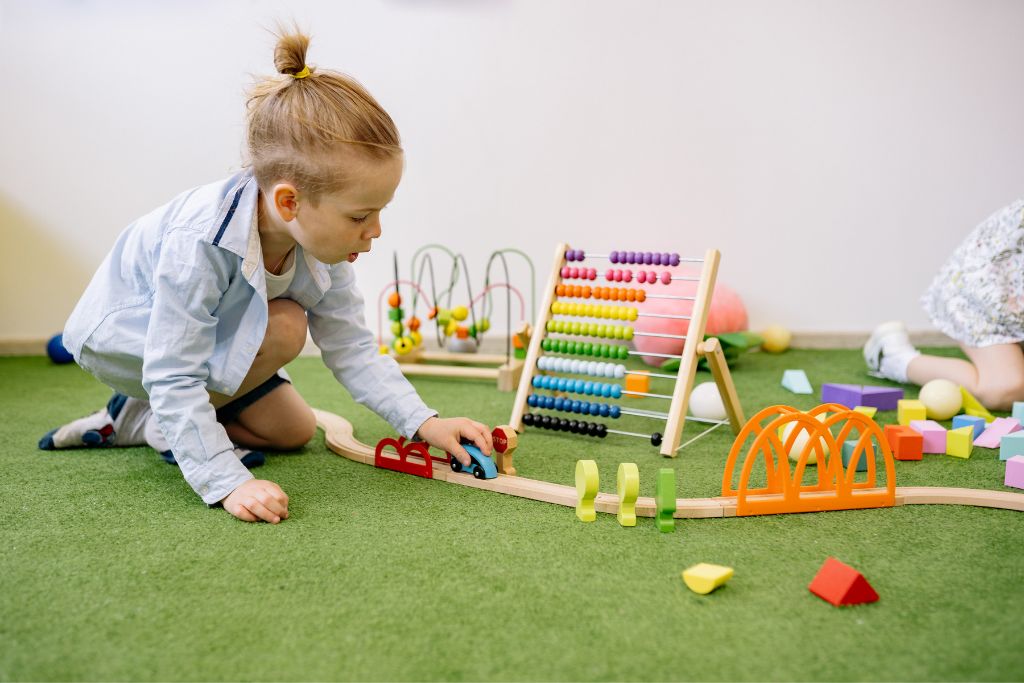 child playing with toy car